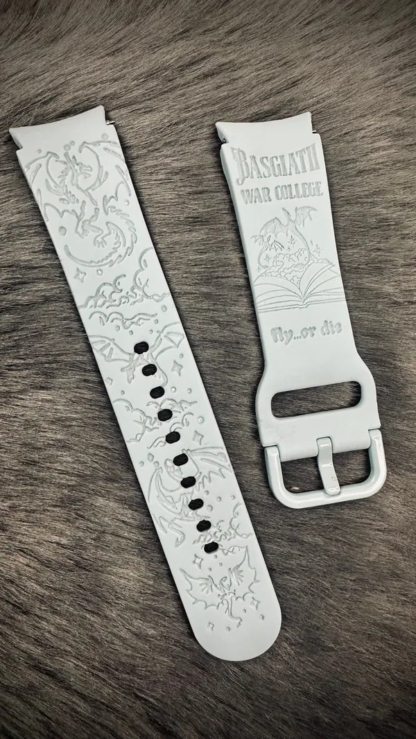 Engraved watch band with dragon artwork.